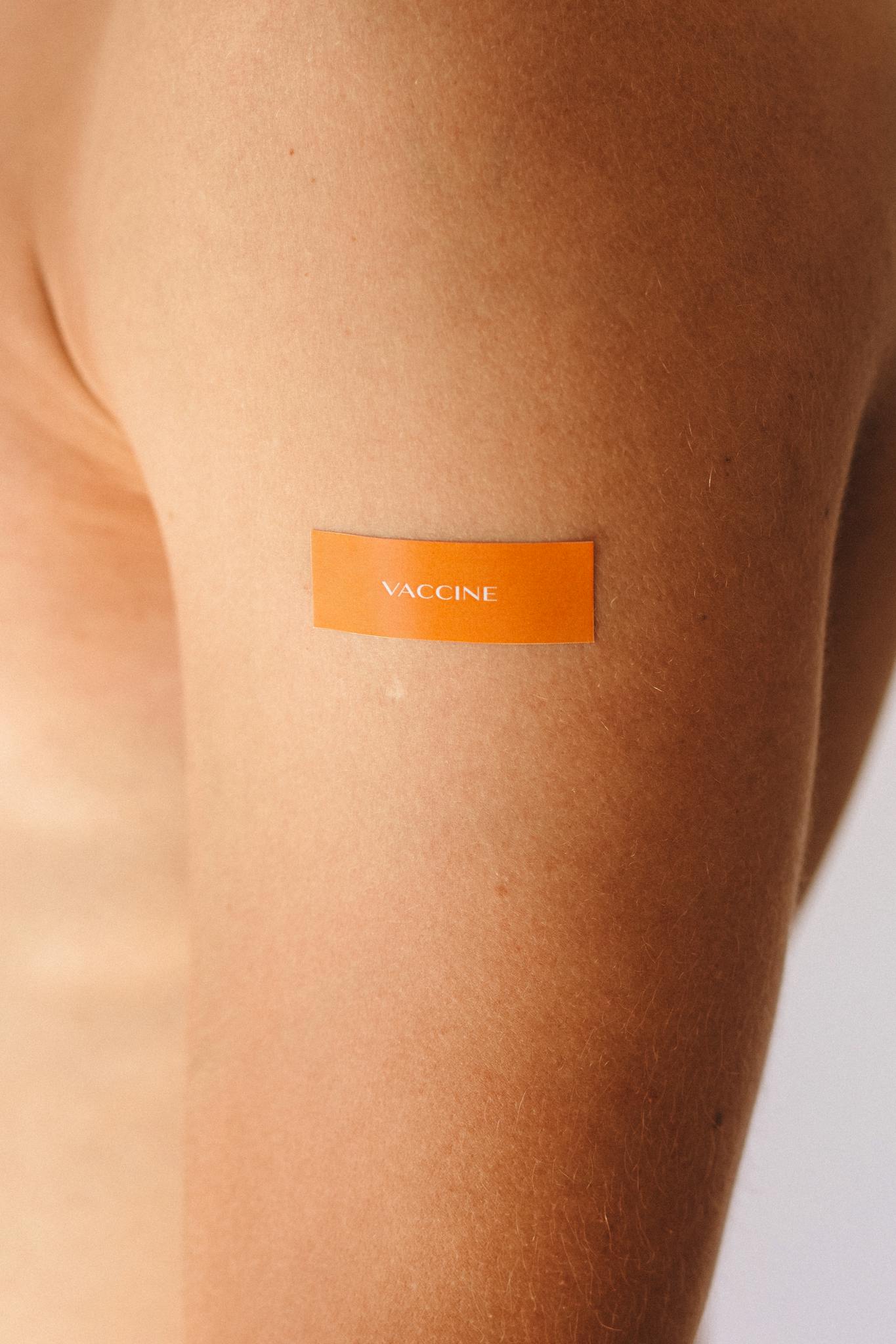 A close-up view of an arm with a vaccine bandage, symbolizing protection and healthcare.